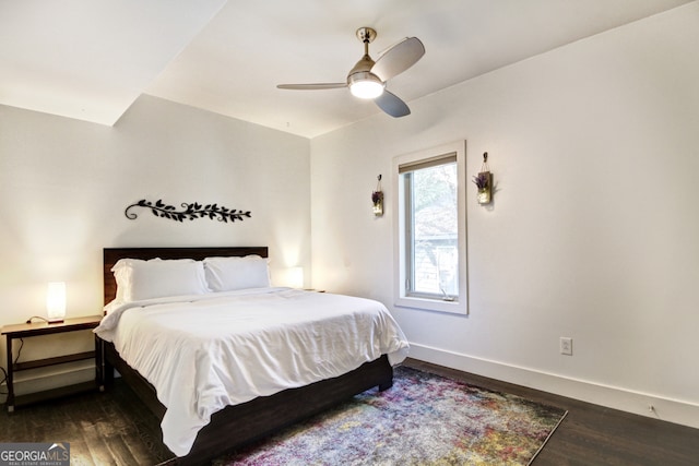 bedroom featuring a ceiling fan, baseboards, and wood finished floors