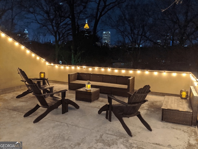 patio at twilight featuring an outdoor hangout area