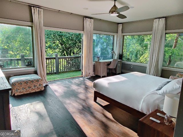 bedroom featuring access to outside, wood finished floors, and a ceiling fan