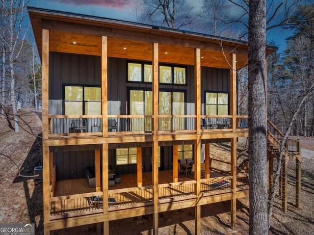 back of property with board and batten siding