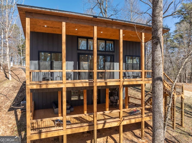 rear view of property with board and batten siding