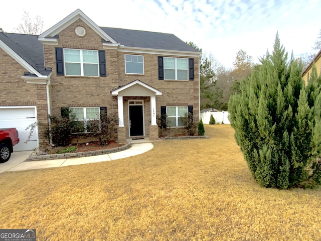 view of front of house with brick siding and a front lawn