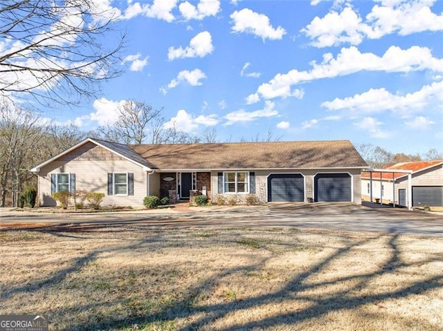 ranch-style home with driveway and an attached garage