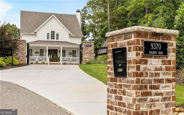 view of front of home featuring covered porch and a chimney