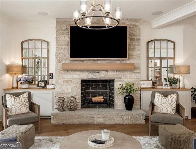 9370 Raldon Rd, Gainesville, GA 30506 - living room with ornamental molding, wood finished floors, a stone fireplace, and a chandelier