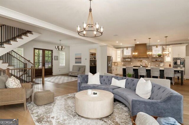 9370 Raldon Rd, Gainesville, GA 30506 - living room featuring a chandelier, stairway, light wood finished floors, crown molding, and recessed lighting