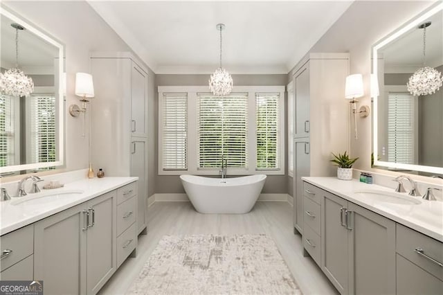 9370 Raldon Rd, Gainesville, GA 30506 - full bathroom with a chandelier, two vanities, a soaking tub, and crown molding