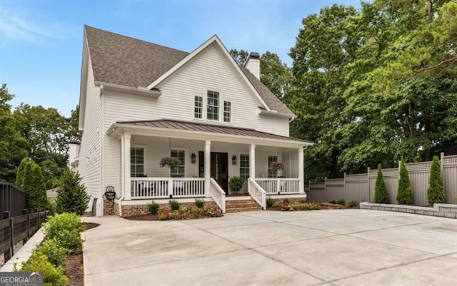 9370 Raldon Rd, Gainesville, GA 30506 - view of front facade with a porch, concrete driveway, a chimney, roof with shingles, and a standing seam roof