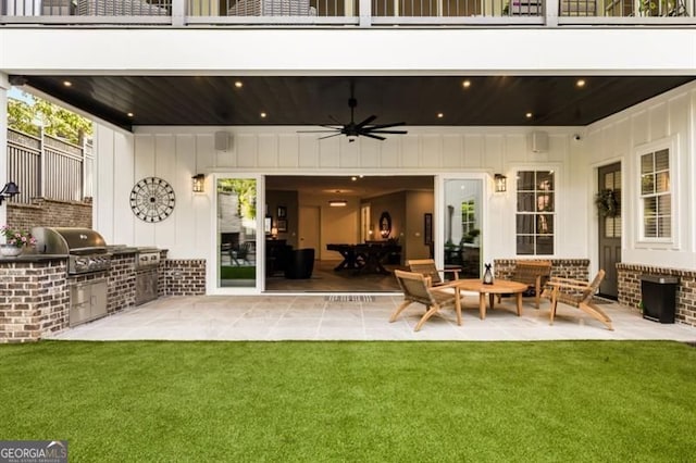 9370 Raldon Rd, Gainesville, GA 30506 - patio / terrace featuring exterior kitchen, ceiling fan, a patio area, and a lawn