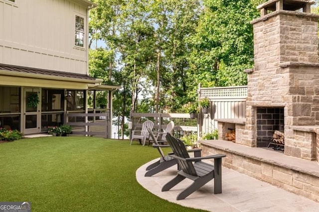 9370 Raldon Rd, Gainesville, GA 30506 - view of grassy yard with an outdoor stone fireplace and a patio area