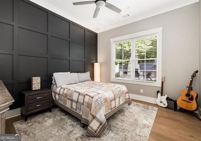 9370 Raldon Rd, Gainesville, GA 30506 - bedroom featuring light wood finished floors, ceiling fan, a decorative wall, and crown molding