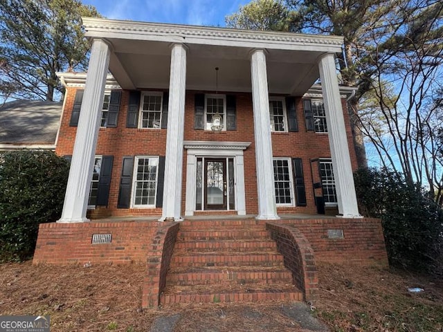 neoclassical / greek revival house featuring brick siding