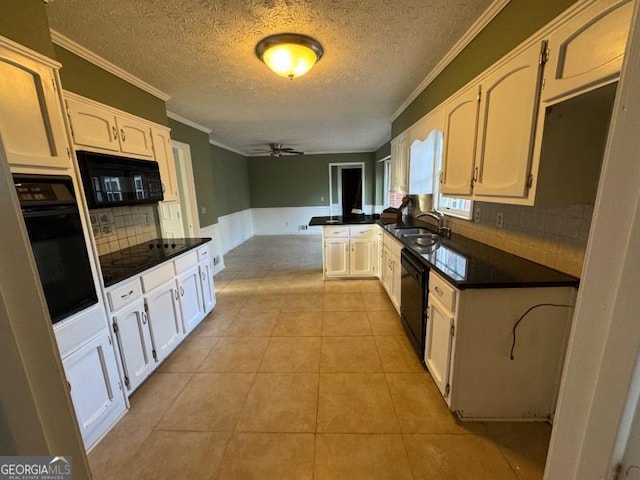 kitchen featuring light tile patterned floors, dark countertops, white cabinetry, a peninsula, and black appliances