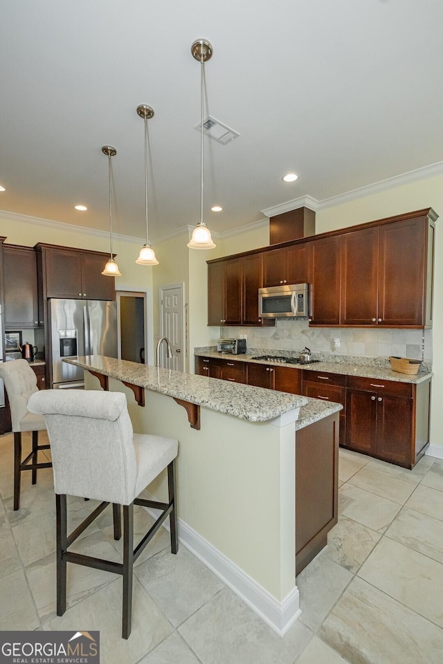 kitchen featuring stainless steel appliances, visible vents, backsplash, and light stone countertops