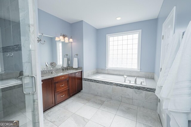 bathroom with a garden tub, double vanity, a sink, a shower stall, and tile patterned floors