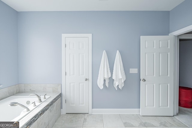 full bathroom with baseboards and a bath