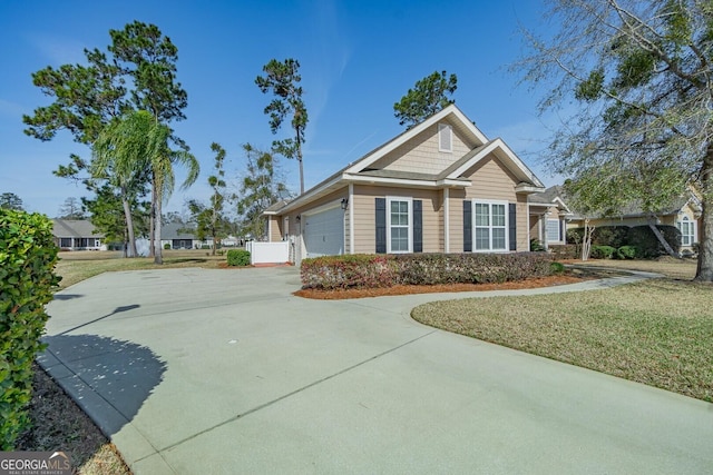 view of front of house with driveway, a garage, and a front lawn