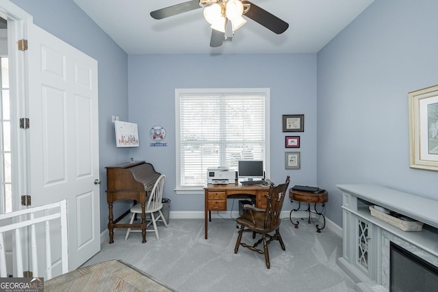 home office with carpet, baseboards, and a ceiling fan