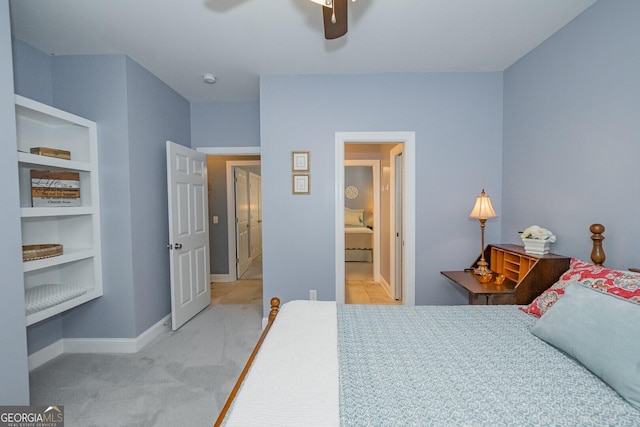 bedroom with light carpet, connected bathroom, baseboards, and ceiling fan