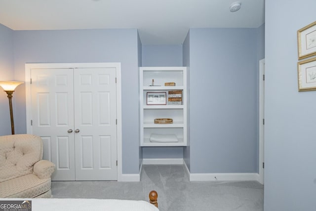 bedroom with a closet, carpet flooring, and baseboards