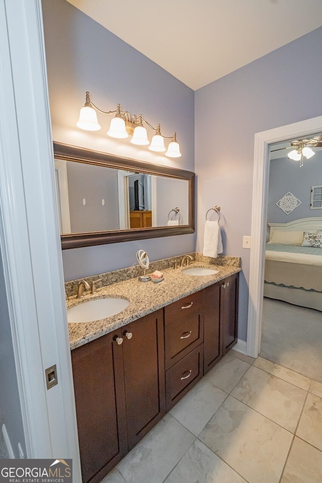 bathroom with a sink, ensuite bath, and double vanity