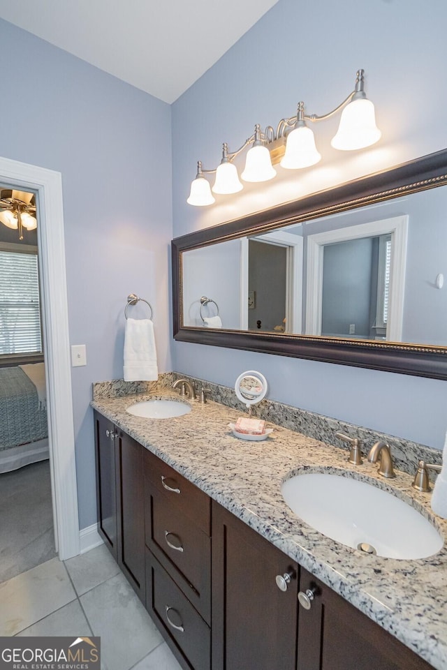 full bathroom featuring double vanity, a sink, and tile patterned floors