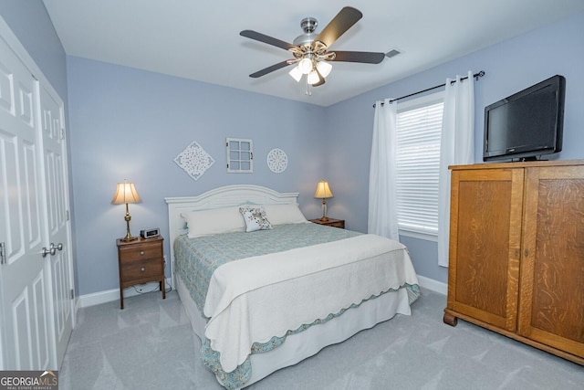 bedroom with a ceiling fan, carpet flooring, visible vents, and baseboards