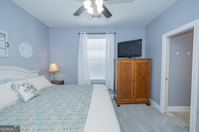 bedroom featuring baseboards, visible vents, ceiling fan, and light colored carpet