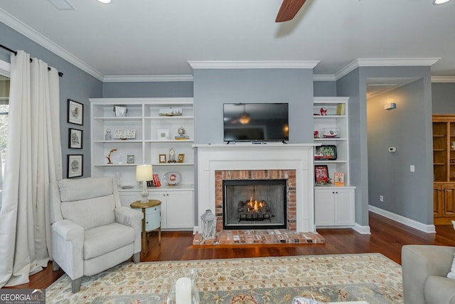 living area featuring a brick fireplace, crown molding, and wood finished floors