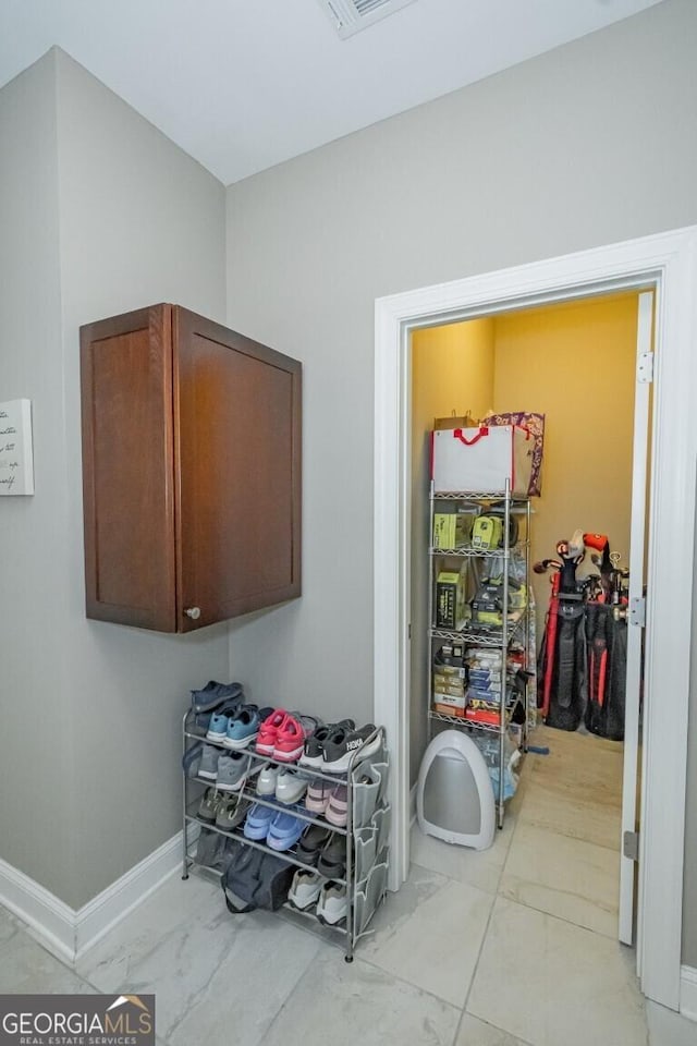 interior space with marble finish floor and baseboards