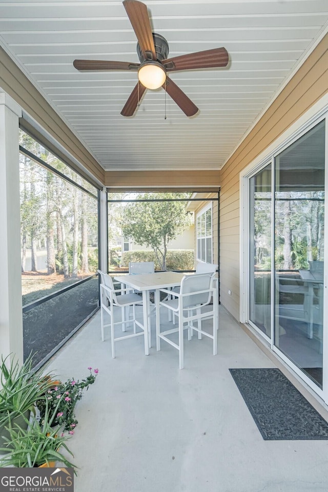 sunroom / solarium with plenty of natural light and a ceiling fan