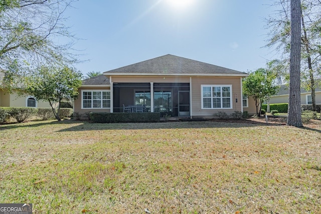 back of property featuring a sunroom and a yard