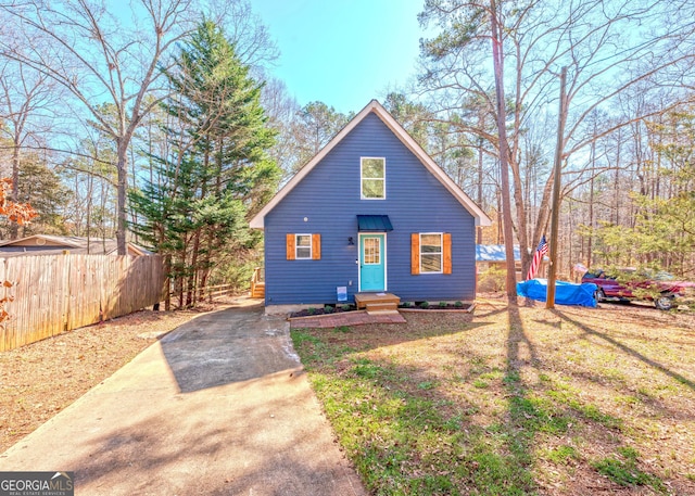 rustic home featuring fence