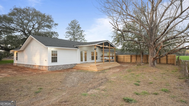 back of property with a shingled roof, a fenced backyard, and a wooden deck