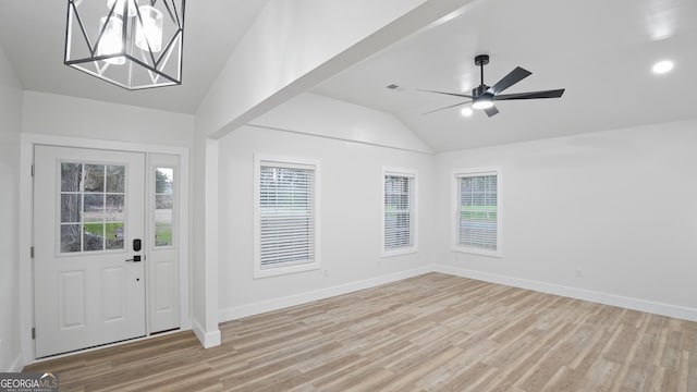 entryway featuring lofted ceiling, visible vents, light wood-style flooring, and baseboards