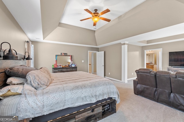 bedroom with baseboards, a tray ceiling, carpet flooring, and ornate columns