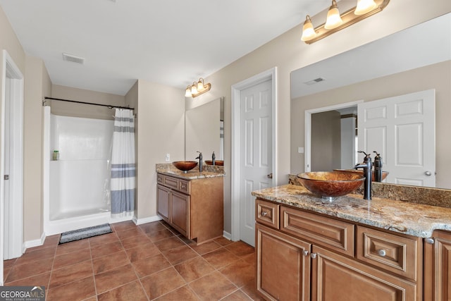 full bathroom featuring tile patterned flooring, visible vents, vanity, and a shower with curtain