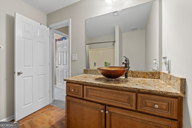 bathroom featuring tile patterned flooring, visible vents, and vanity