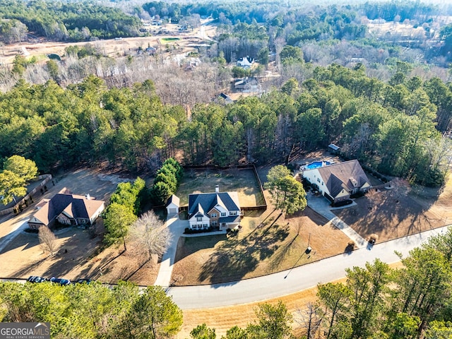 aerial view featuring a wooded view