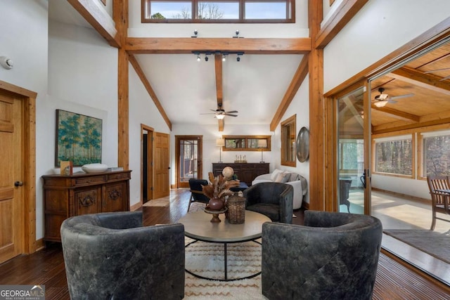 living room with beamed ceiling, wood finished floors, and a wealth of natural light