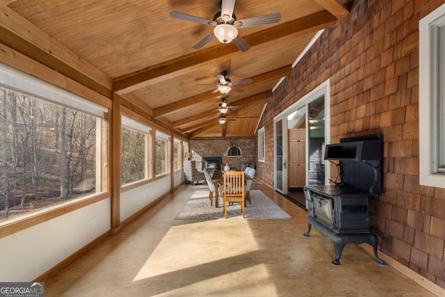 sunroom / solarium featuring vaulted ceiling with beams, a wood stove, and wood ceiling