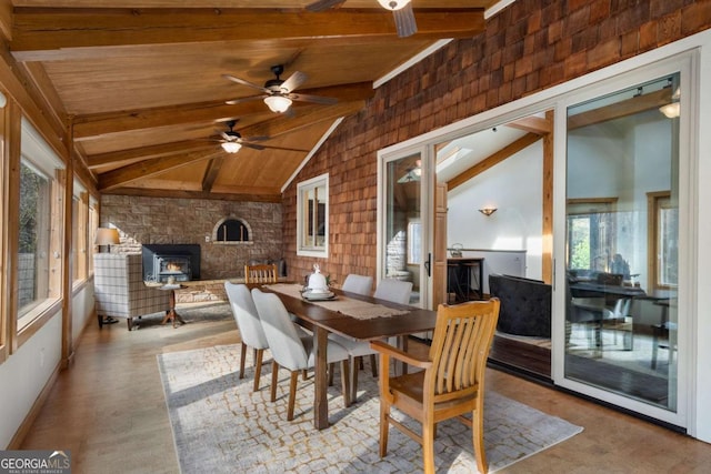 dining room with lofted ceiling with beams, wooden ceiling, wood finished floors, and a wood stove