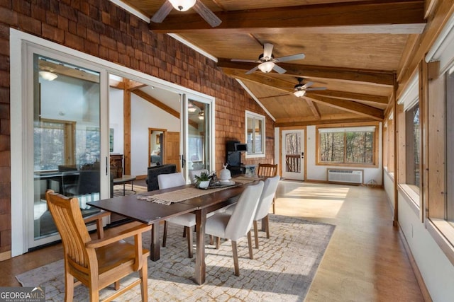 sunroom with vaulted ceiling with beams, wooden ceiling, ceiling fan, and an AC wall unit