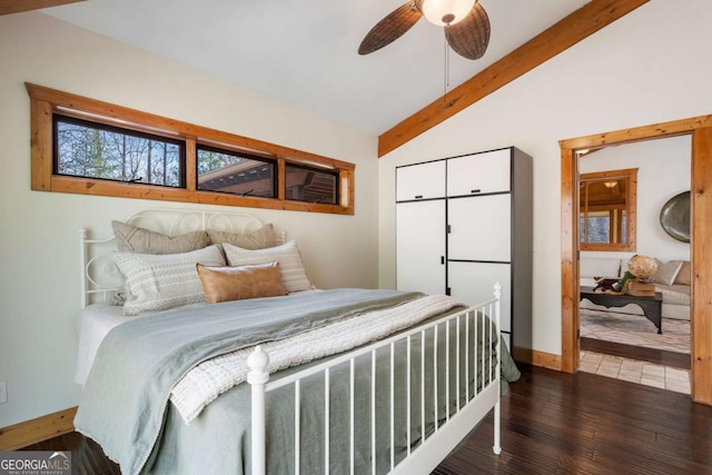 bedroom featuring vaulted ceiling with beams, a ceiling fan, baseboards, and wood finished floors