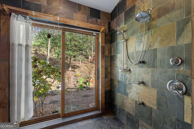 bathroom with tiled shower