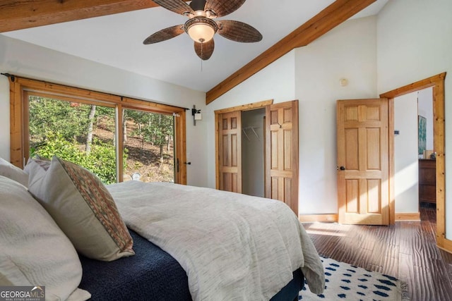 bedroom with a closet, beamed ceiling, wood finished floors, and a ceiling fan