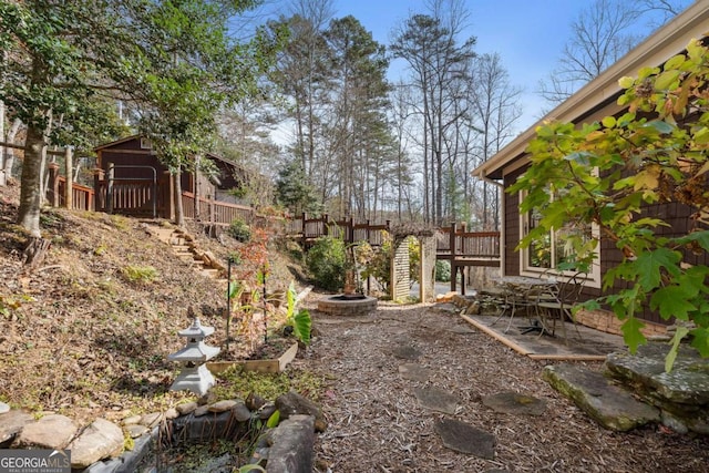 view of yard with fence and a deck