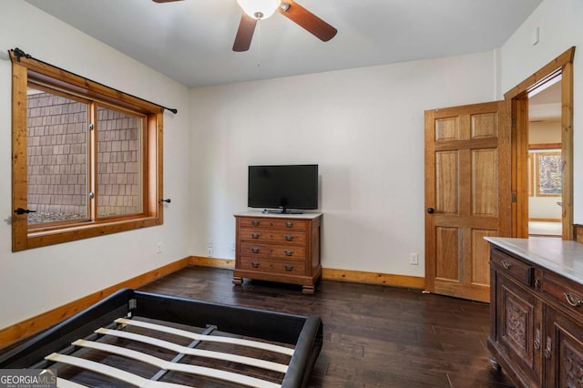 bedroom with dark wood-style floors, baseboards, and a ceiling fan