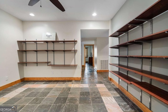 interior space with ceiling fan and visible vents