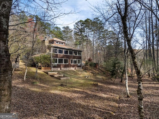 back of house featuring a sunroom